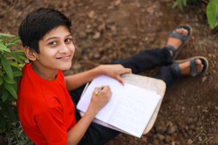 Cute indian little child studying at agriculture field