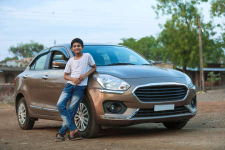 Cute Indian child with carの写真素材