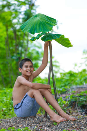 Cute indian little child enjoying with natureの写真素材