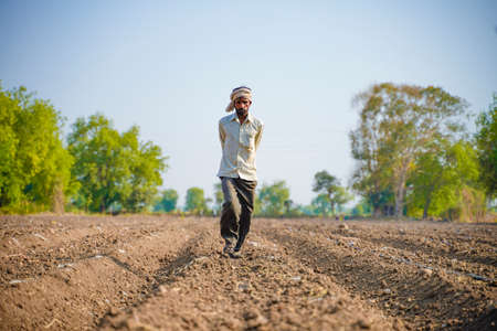 Indian farmer or labour Drip irrigation pipe assemble in agriculture field. rural scene.