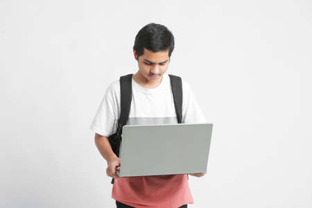indian male college student using laptop