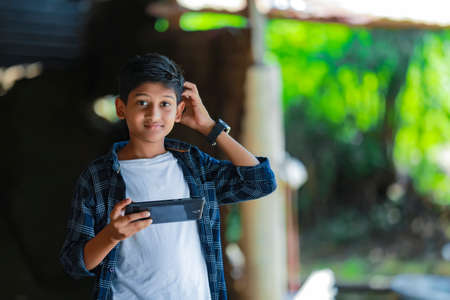 young indian cute child with smartphoneの写真素材
