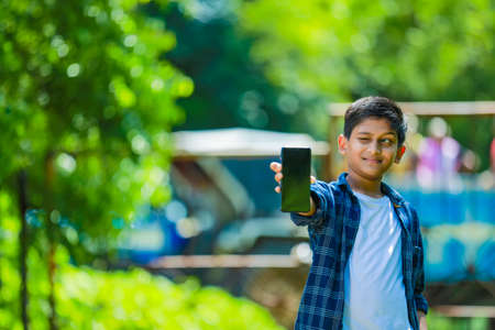 indian cute child showing showing smartphoneの写真素材