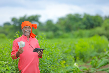 indian farmer with money and tabletの写真素材