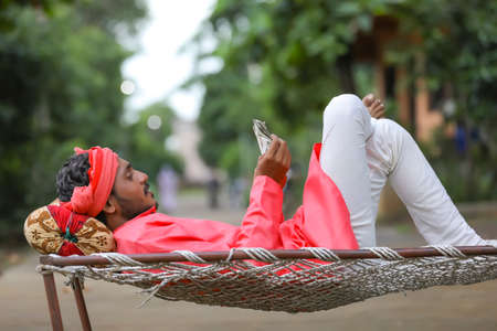 Young indian farmer counting moneyの写真素材