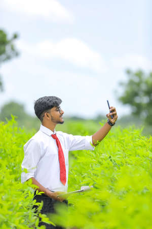 Young indian agronomist take selfie in fieldの写真素材