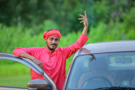 young indian farmer with new carの写真素材