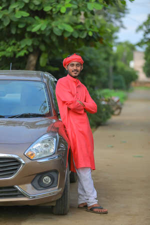 young indian farmer with new car