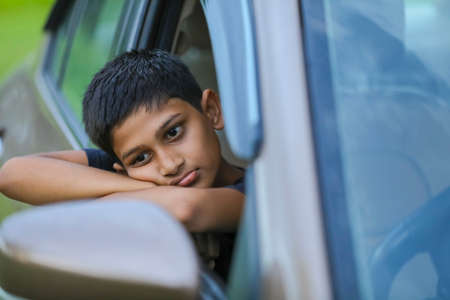 Cute Indian child showing face expression in car