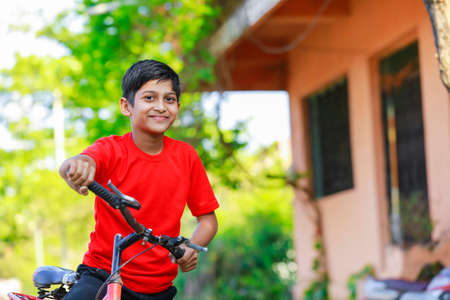 indian little boy enjoy cycle riding