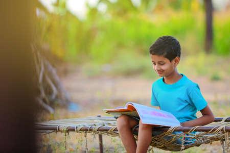 Cute indian child studying at homeの写真素材