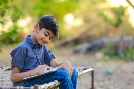 Cute indian child studying at home