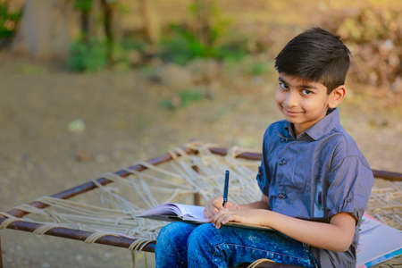 Cute indian child studying at homeの写真素材