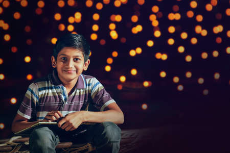 Young indian cute child showing slateの写真素材