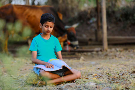 Cute indian child studying at home