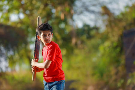 Rural Indian Child Playing Cricketの写真素材