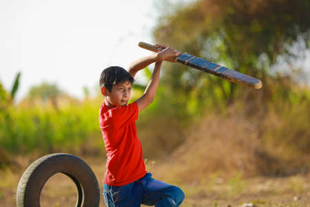 Rural Indian Child Playing Cricketの写真素材