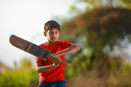 Rural Indian Child Playing Cricketの写真素材