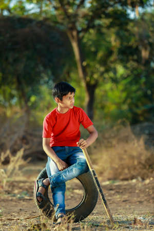 Rural Indian Child Playing Cricket