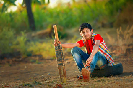 Rural Indian Child Playing Cricket.の写真素材