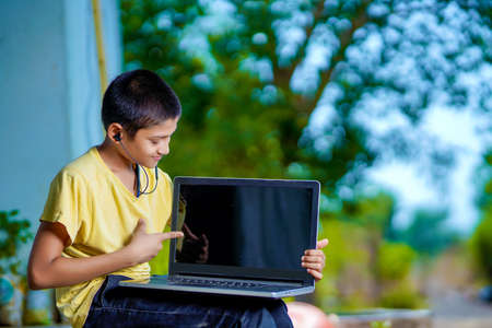 Asian boy using Laptop computer for online study homeschooling during home quarantine....