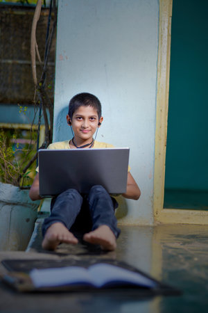 Asian boy using Laptop computer for online study homeschooling during home quarantine. homeschooling, online study, home quarantine, online learning,  virus or education technology conceptの写真素材