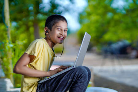 Asian boy using Laptop computer for online study homeschooling during home quarantine....