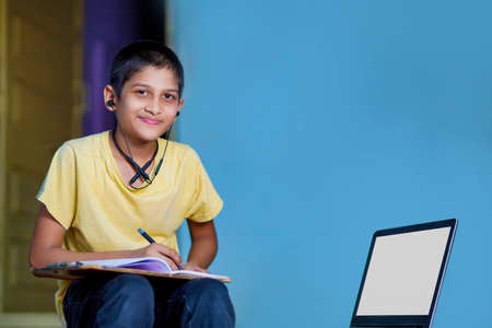 Asian boy using Laptop computer for online study homeschooling during home quarantine....
