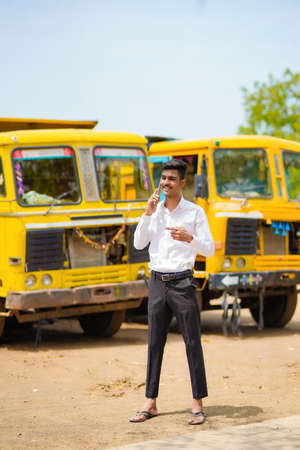 Young indian businessman with his freight forward lorry or truck.の写真素材