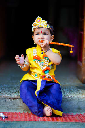 happy Janmashtami Greeting Card showing Little Indian boy posing as Shri krishna or kanha/kanhaiya...