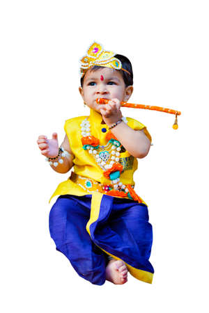 happy Janmashtami Greeting Card showing Little Indian boy posing as Shri krishna or kanha/kanhaiya with Dahi Handi picture and colourful flowers.の写真素材