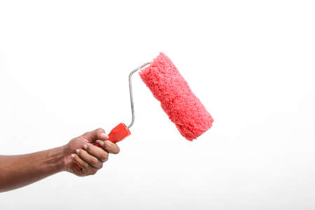 Man hand holding a paint roller isolated on a white background.の写真素材
