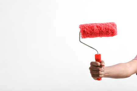 Man hand holding a paint roller isolated on a white background.の写真素材