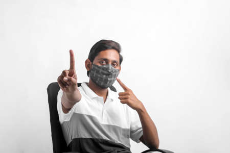 young indian man wearing mask for protection against virus.の写真素材