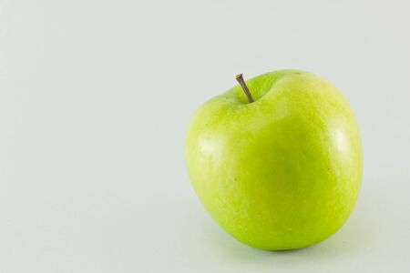 Green apple isolated on white backgroundの写真素材