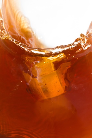 Ice cube dropping on soft drinkの写真素材