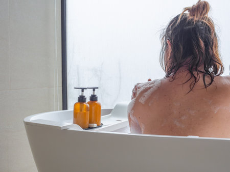 Serene bath moment with natural light, frosted glass, and gentle foam. Promotes skin care,...