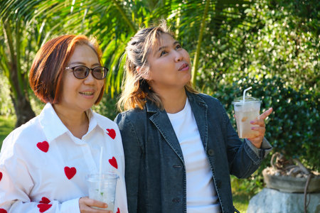 Asian friends walking and laughing together. Celebrate joy, connection, and everyday friendship in...