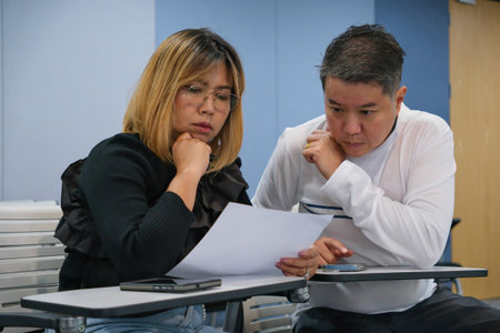 Focused brainstorming in a classroom settingâ€”two learners deeply engaged in collaborative...