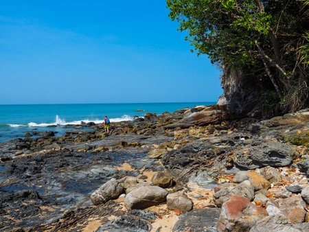 LANTA ISLAND a wondrous place, People stand alone on the back stone and lighthouse in backgroundの写真素材