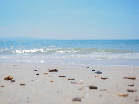 Small stone, sand on the beach and  blue sky backgroundの写真素材