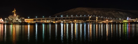 Night view of Tromso Bridge with lights in the city of Tromso in Norwayの写真素材