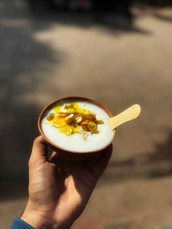 Healthy breakfast with yogurt and nuts in a cup on the tableの写真素材