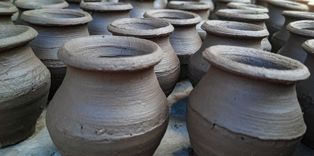 Clay pots in a pottery workshop, closeup of photo