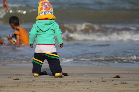 Unidentified children playing on the beachの写真素材