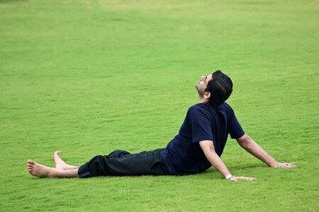 A men taken rest over green grassland の写真素材