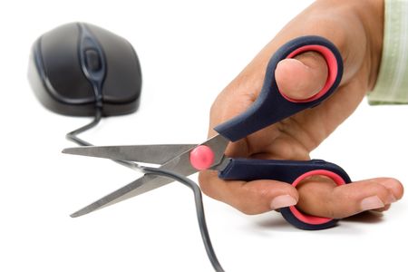 Mouse wire cutting by a scissors over white background の写真素材