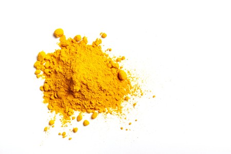 Pile of Turmeric powder isolated on a white background
