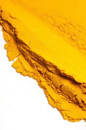 Pile of Turmeric powder isolated on a white backgroundの写真素材