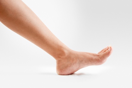 Female  lower legs with beautiful healthy feet isolated on white background